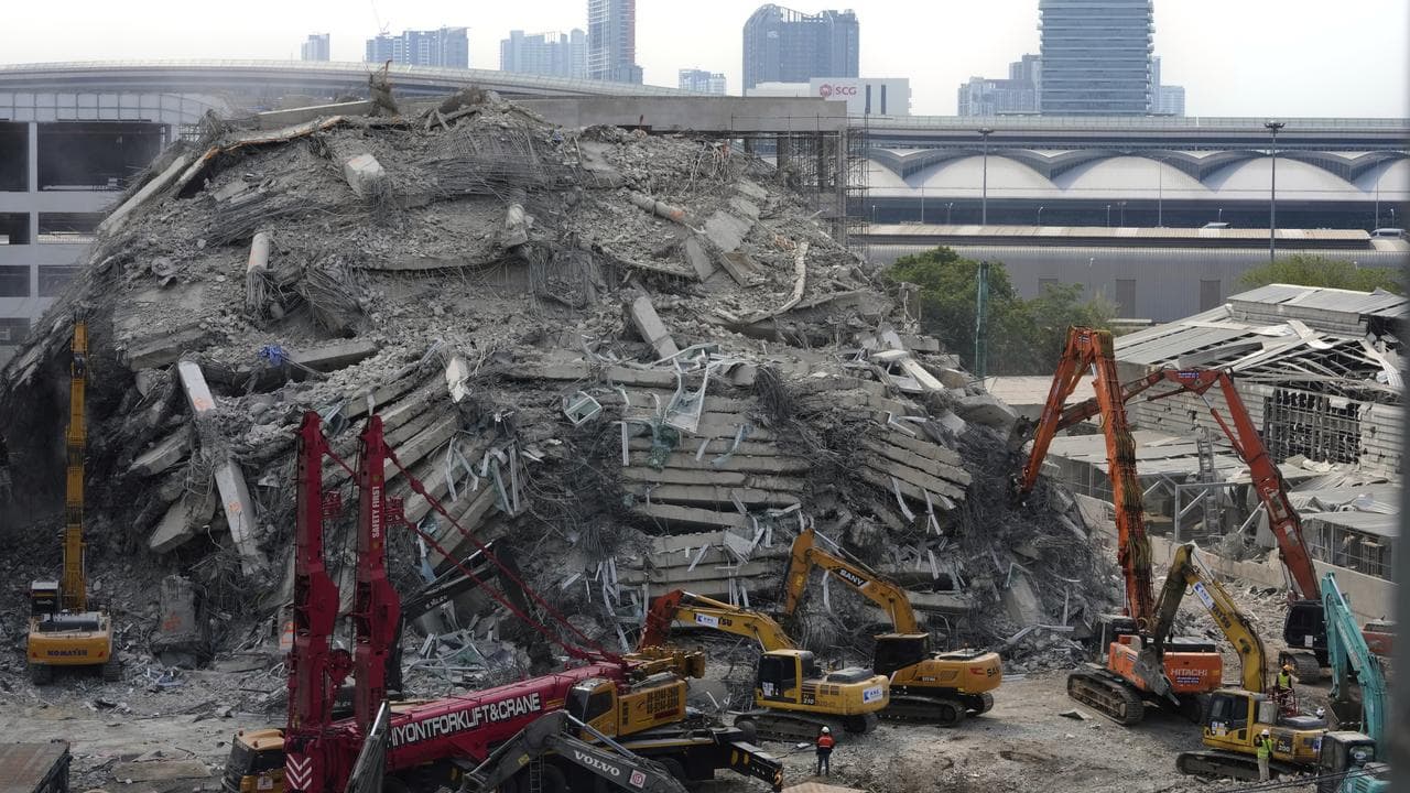 Heavy machinery at the site of a collapsed building in Bangkok