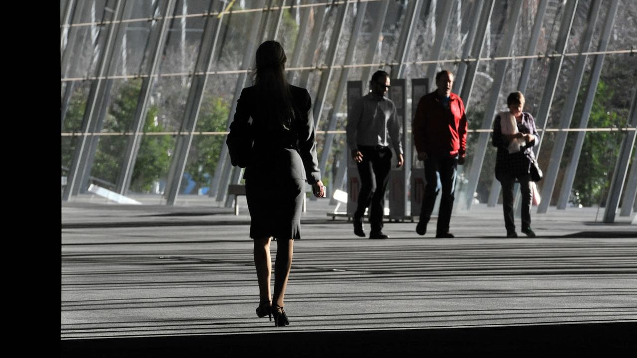 A business woman is seen walking in Melbourne