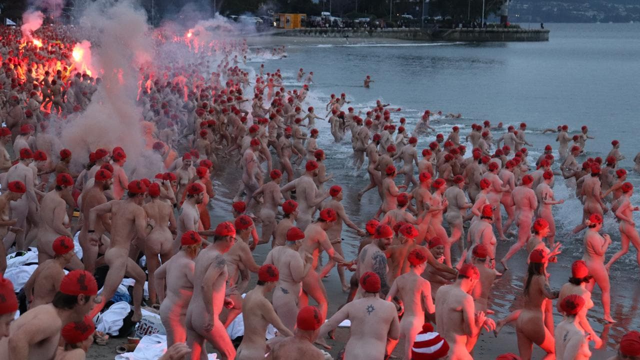 Swimmers participate in the nude winter solstice swim in Tasmania