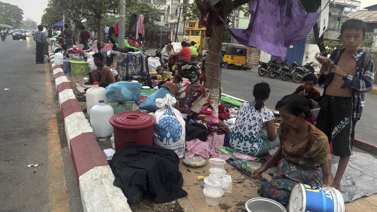Earthquake victims rest on the pavement in Mandalay, Myanmar