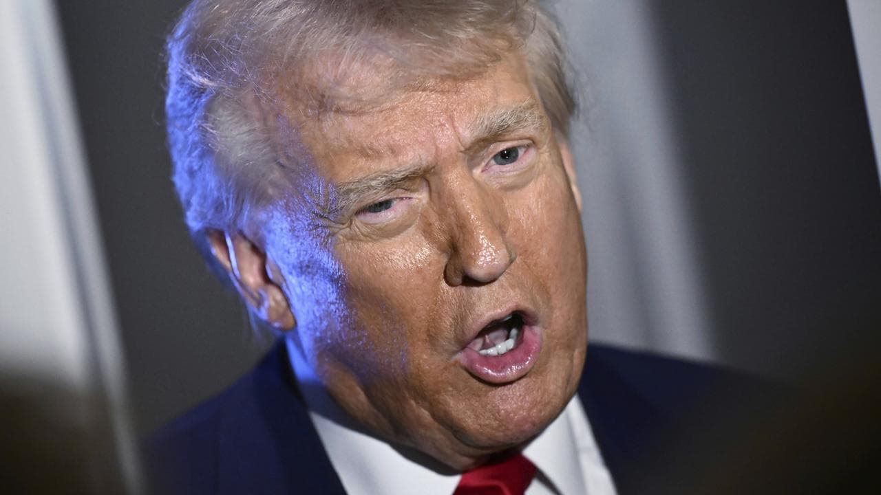 President Donald Trump speaks to reporters on board Air Force One