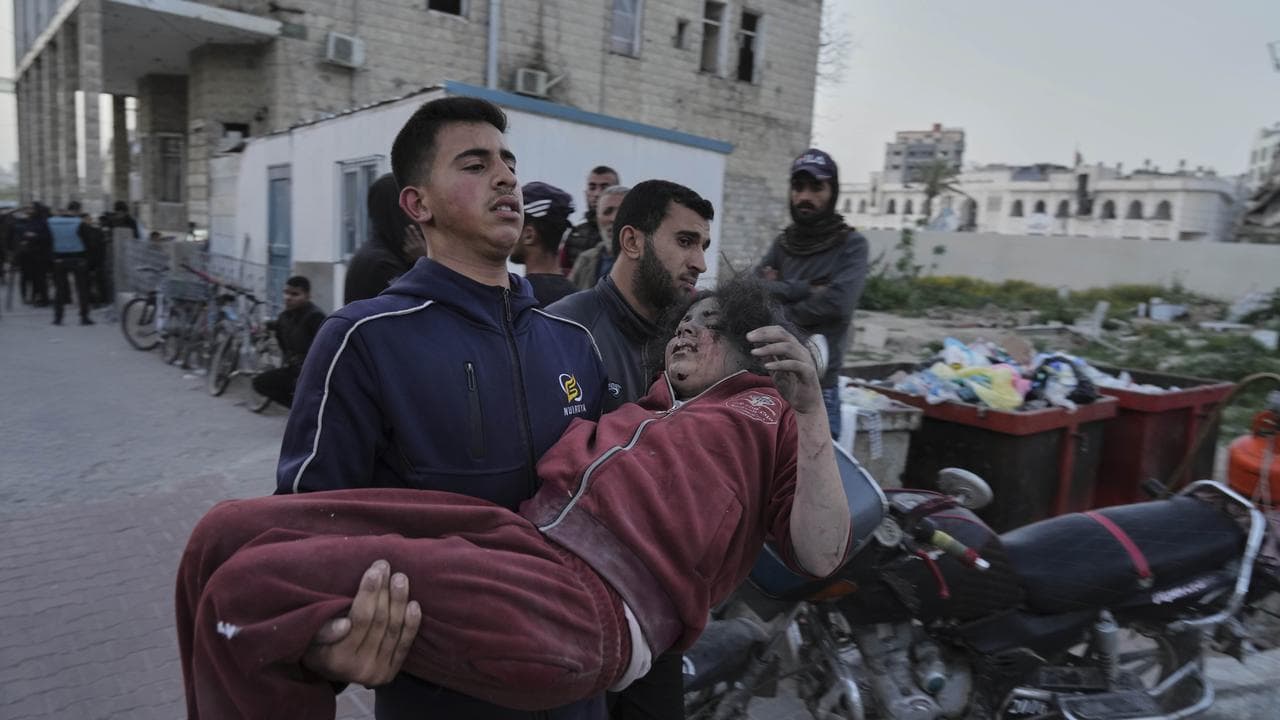 Palestinians who were injured in an Israeli air strike in Gaza City
