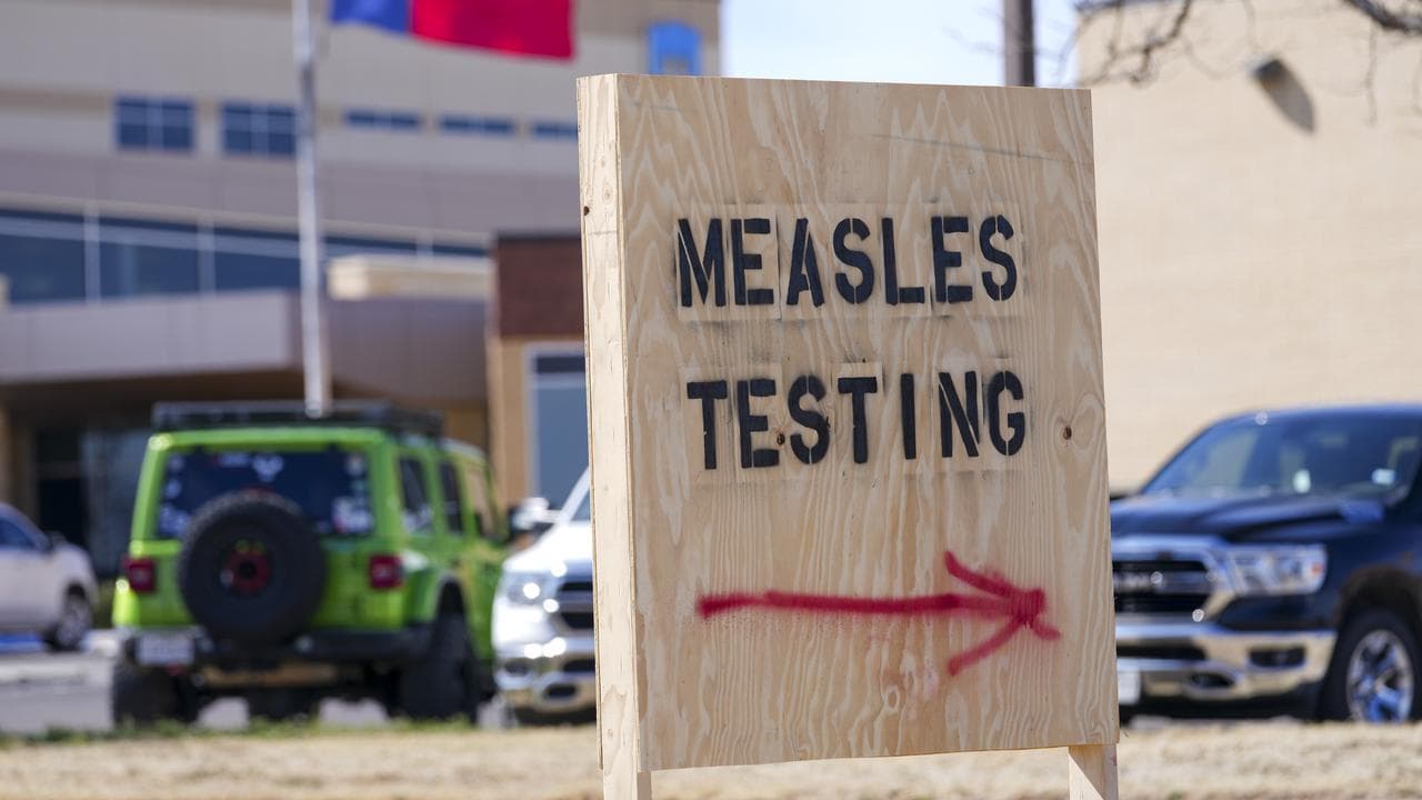 A sign outside a hospital offering measles testing,