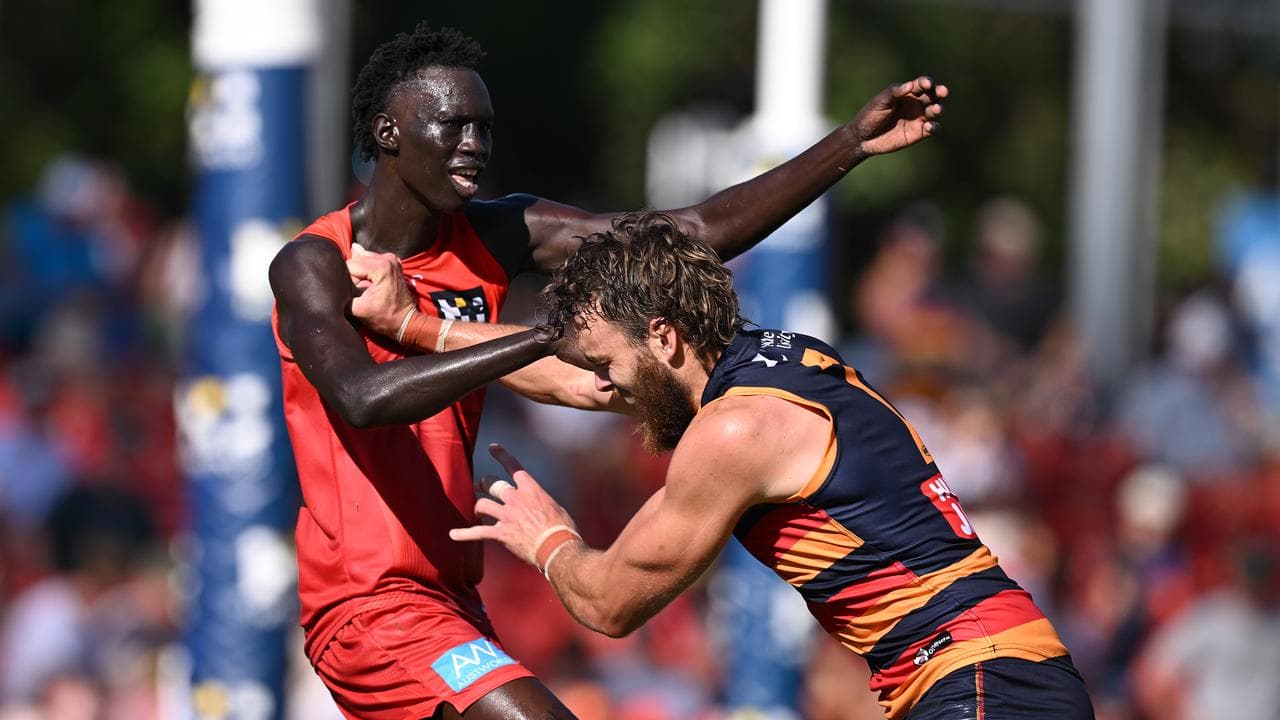 Mac Andrew of the Suns and Riley Thilthorpe of the Crows