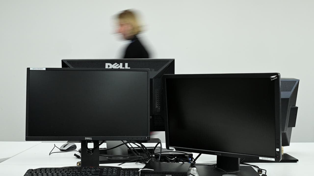Person walks by computers
