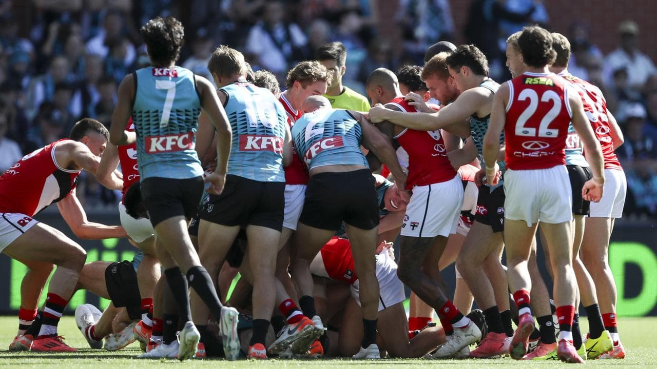 Scuffling Port Adelaide and St Kilda players.