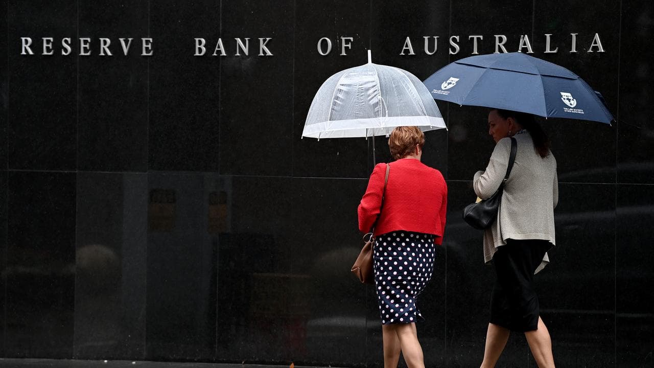 Women walk past the Reserve Bank building in Sydney