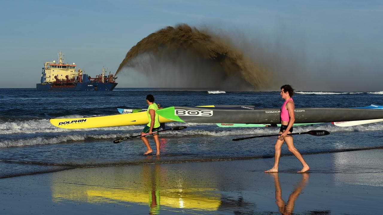 A suction hopper dredger rainbowing sand at Broadbeach