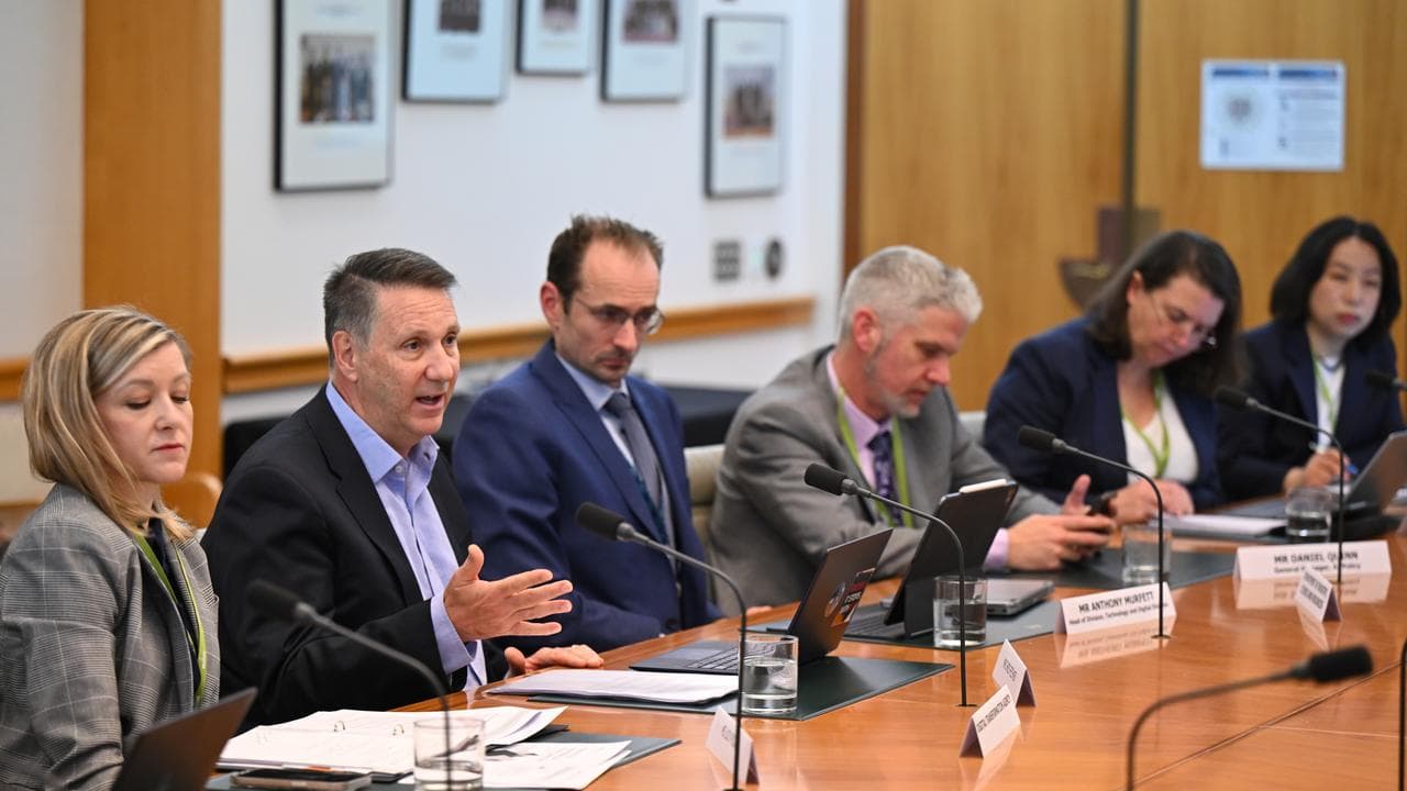 People speak at a Senate inquiry into artificial intelligence