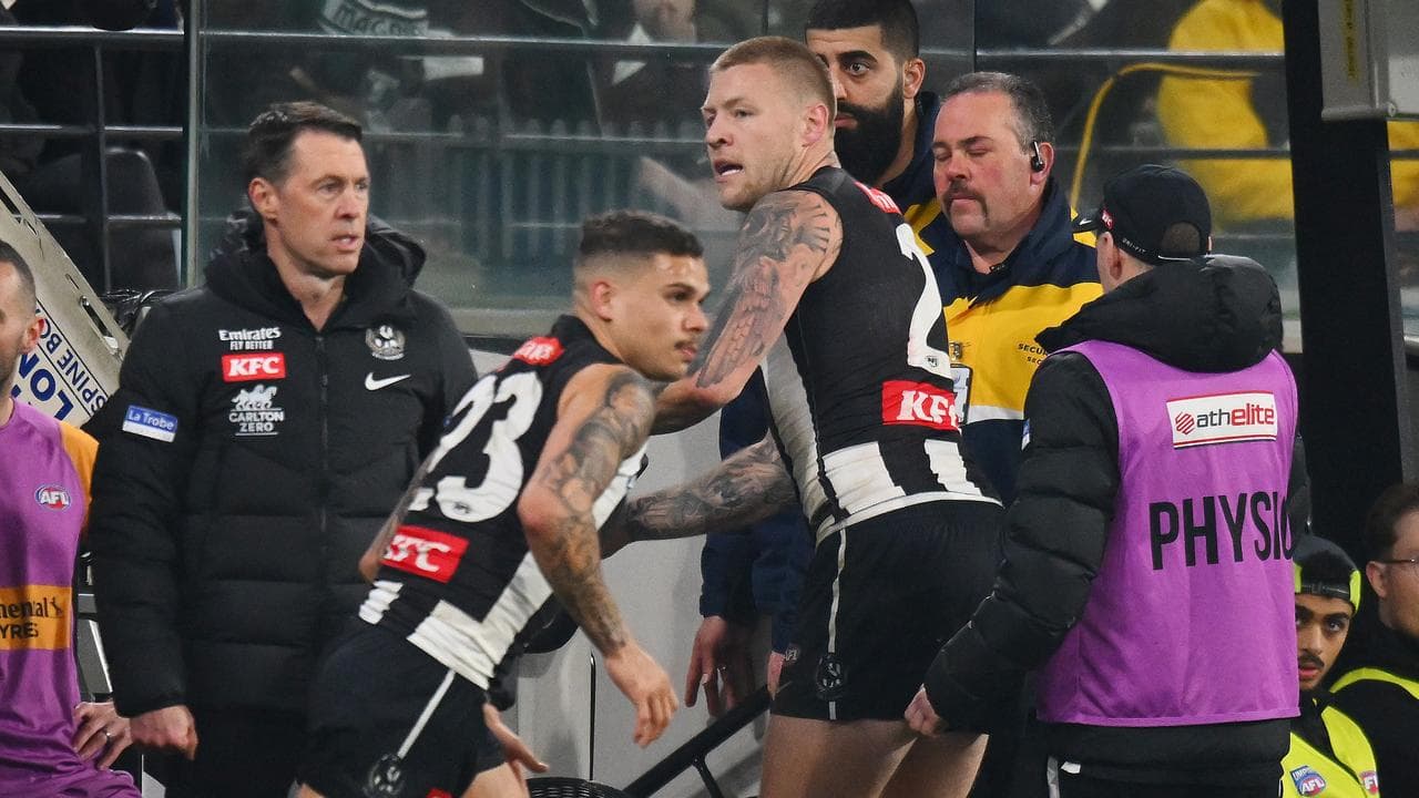 Craig McRae (left) checks on Jordan De Goey (centre)