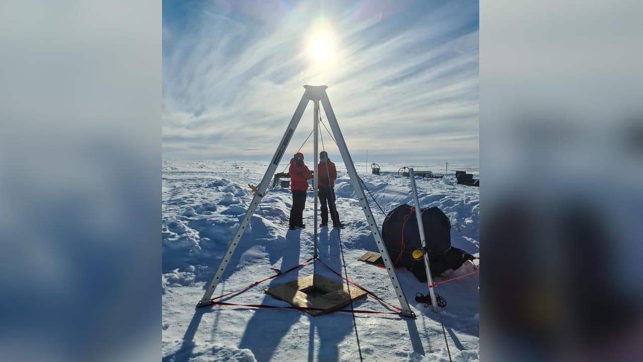 Researchers drill a borehole to test an ice shelf in Antarctica.