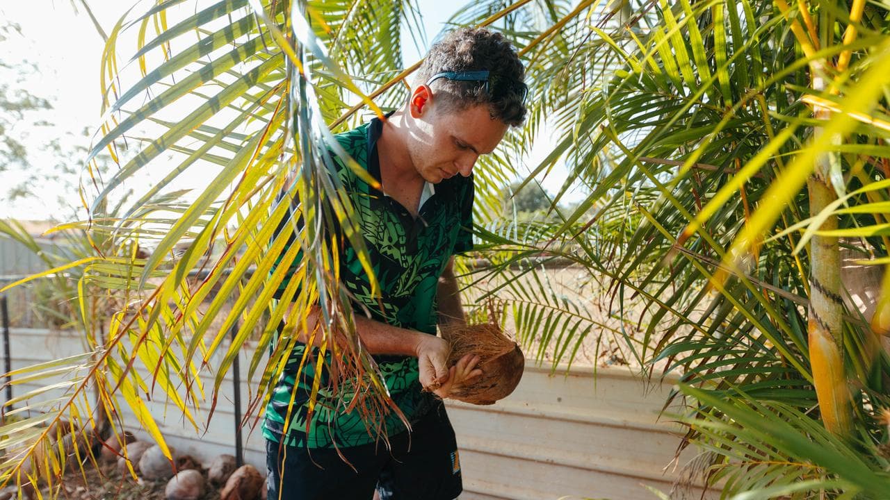 Malachai Clements in his backyard orchard