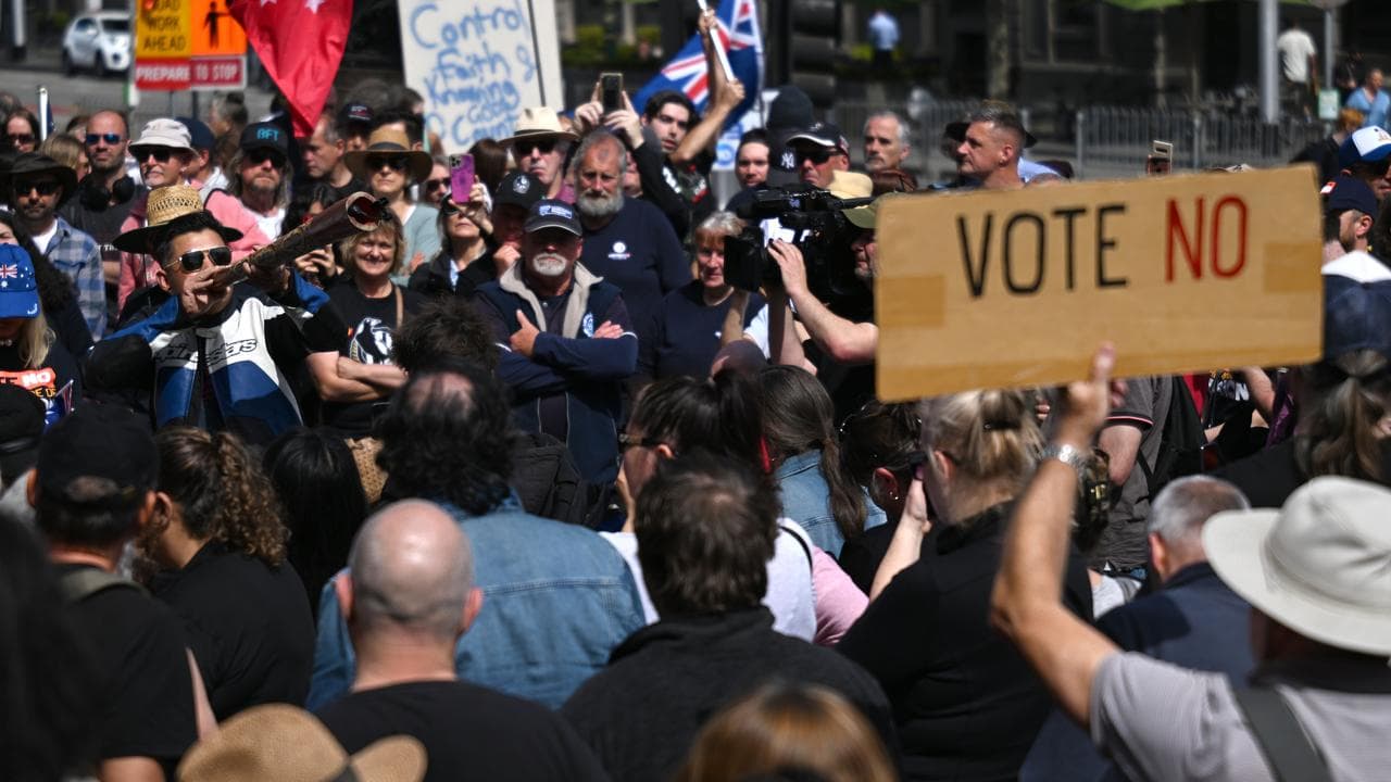 Person plays didgeridoo at a referendum 'no' vote rally in 2023