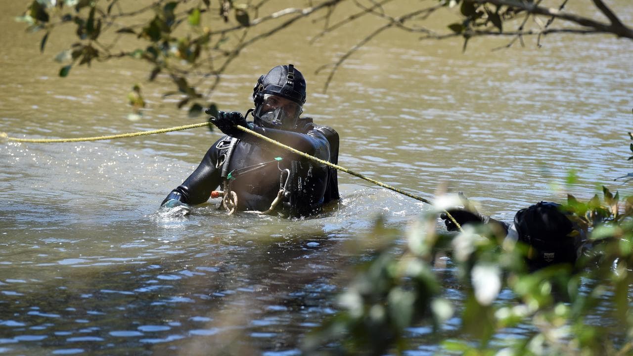 Police divers searching the Pimpama River