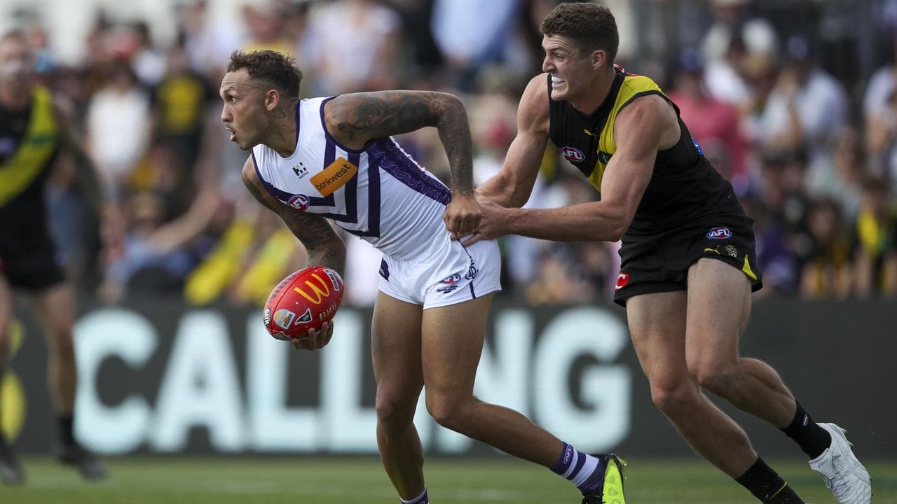 Shai Bolton (left) is tackled by Richmond's Ben Miller.