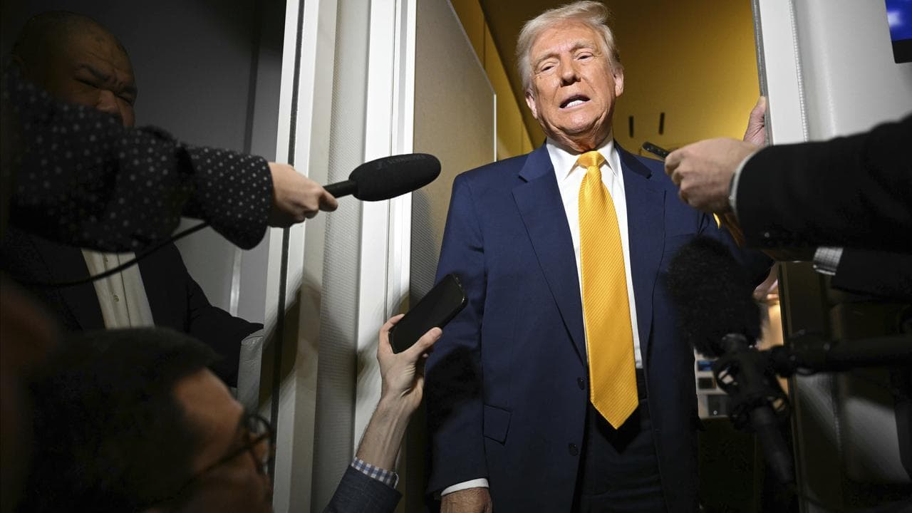 President Donald Trump speaks to the reporters on board Air Force One.