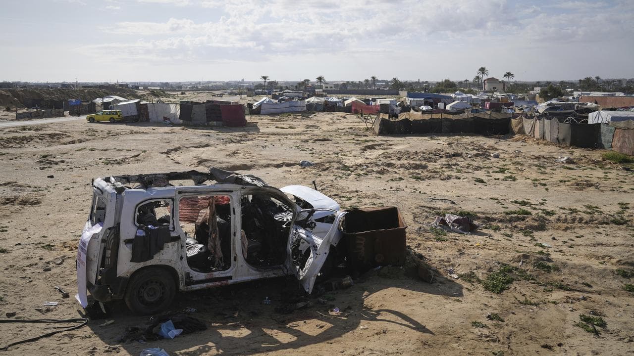 The wreckage of a car struck earlier by an Israeli army attack