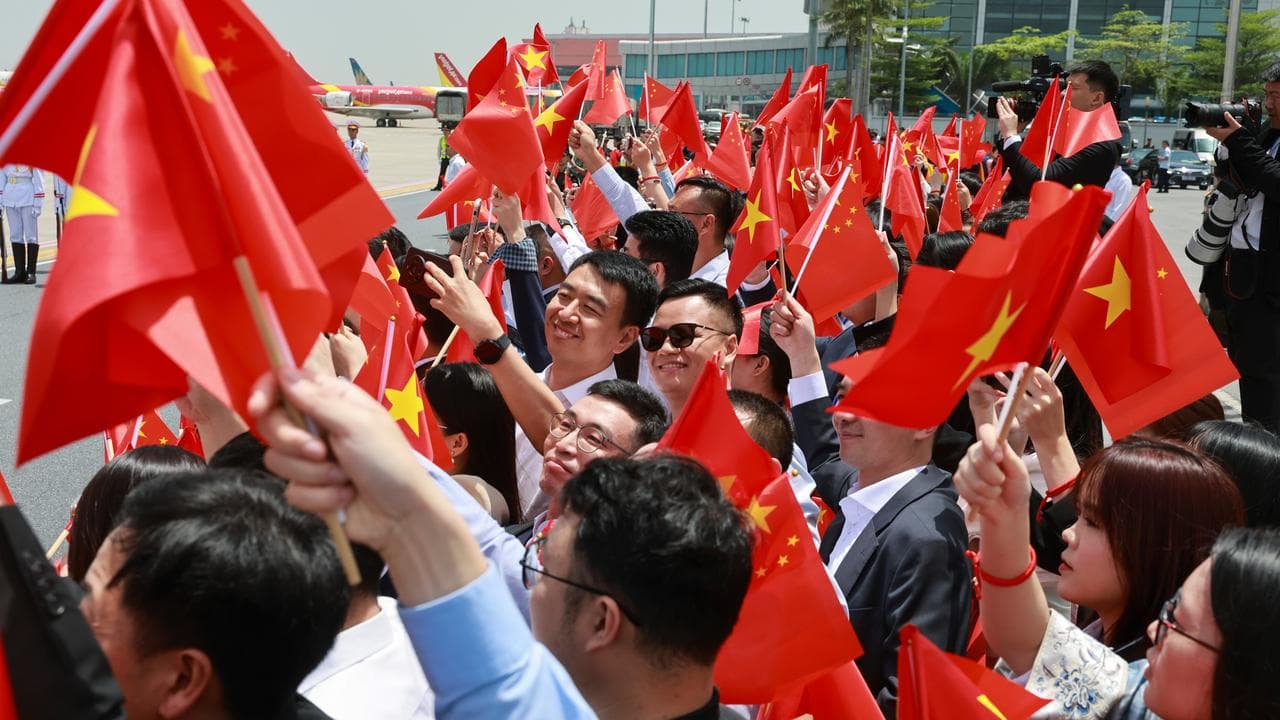 People wave Chinese flags