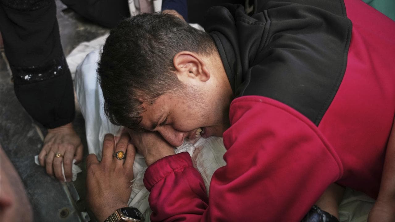 A relative mourn over the body of Abdullah Habbash before his funeral