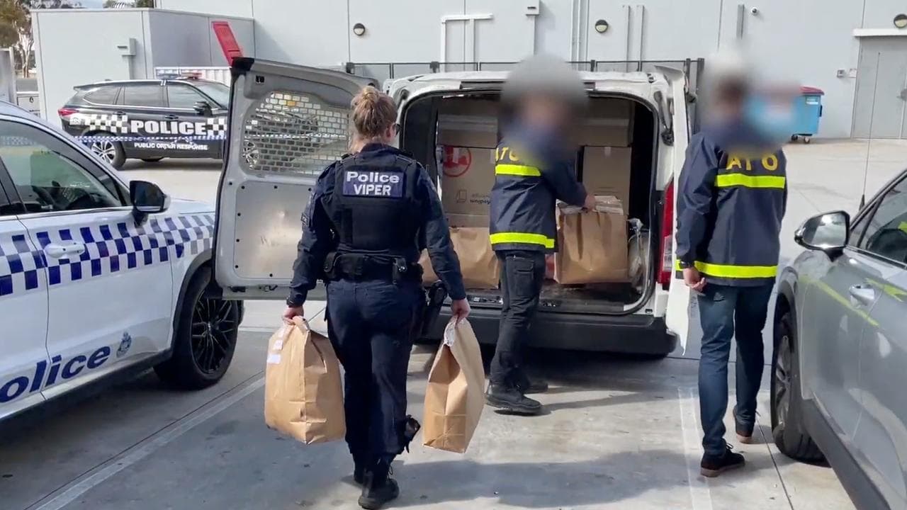 Police during raids on tobacco shops in Melbourne