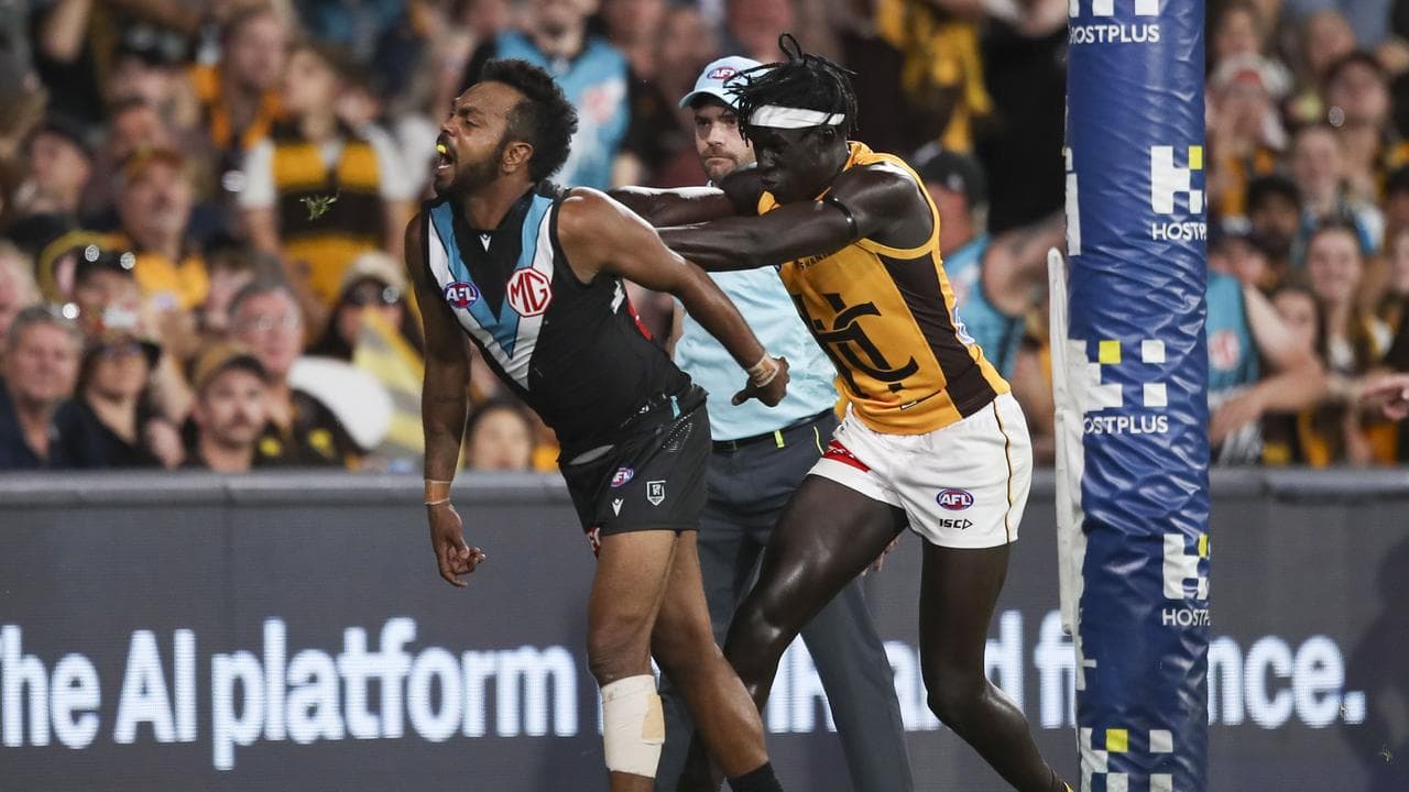Willie Rioli pushed in the back by Hawthorn's Changkuoth Jiath.