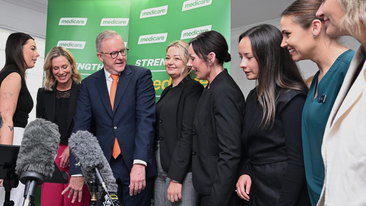 Prime Minister Anthony Albanese poses with clinicians for a photo