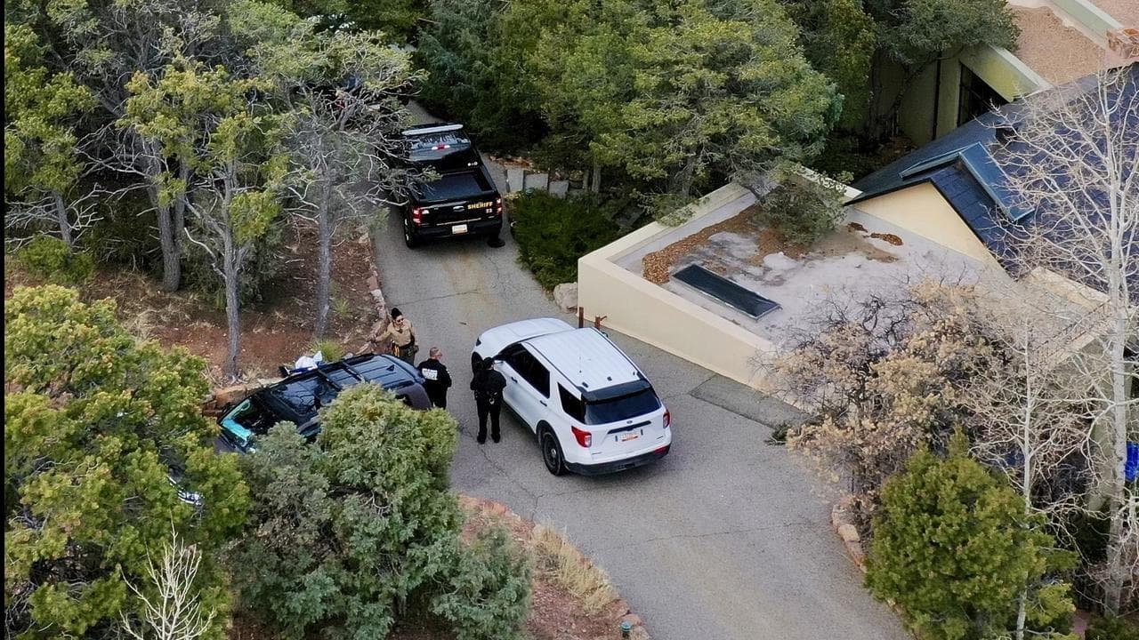 Law enforcement officials outside the Hackman home in Santa Fe