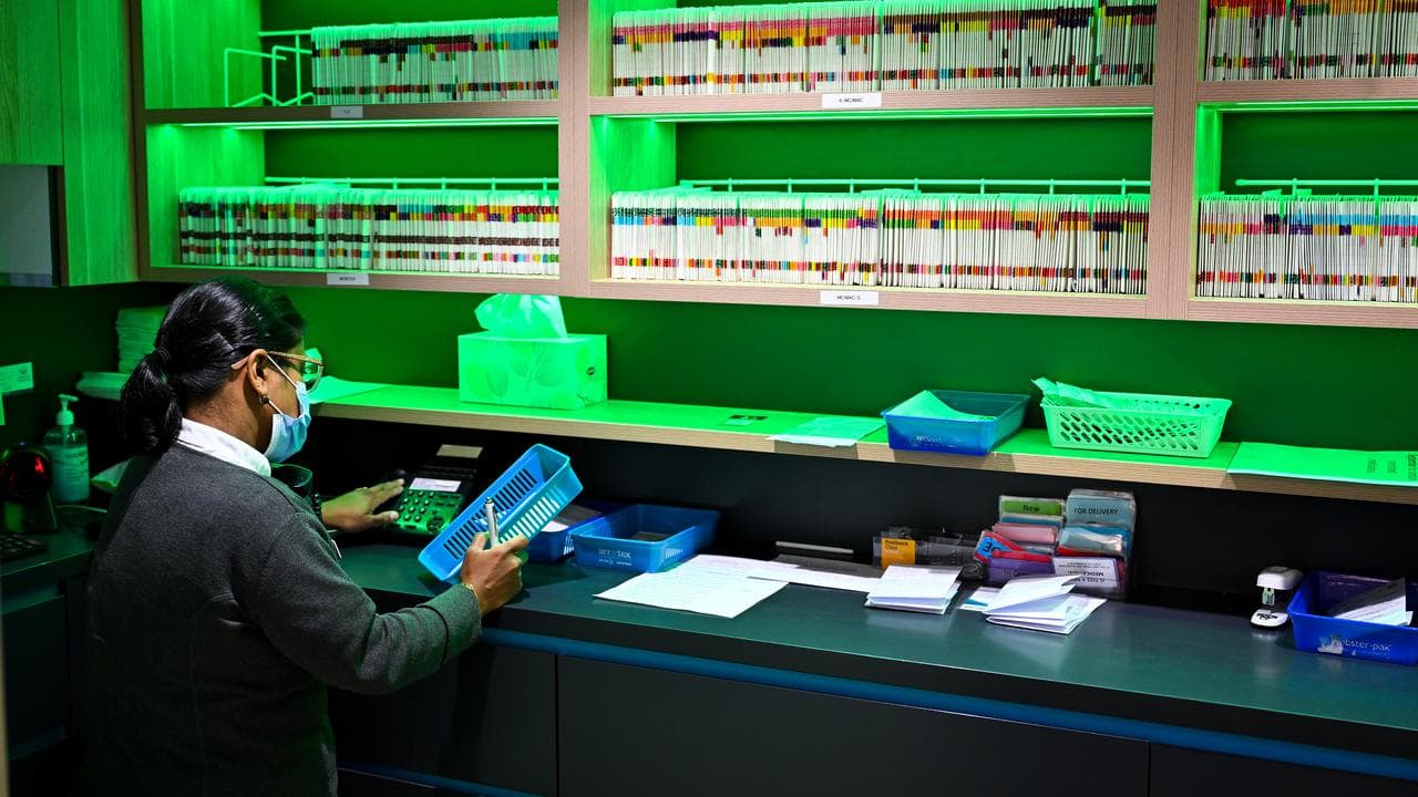 A pharmacist prepares scripts at National Chemist pharmacy in Canberra
