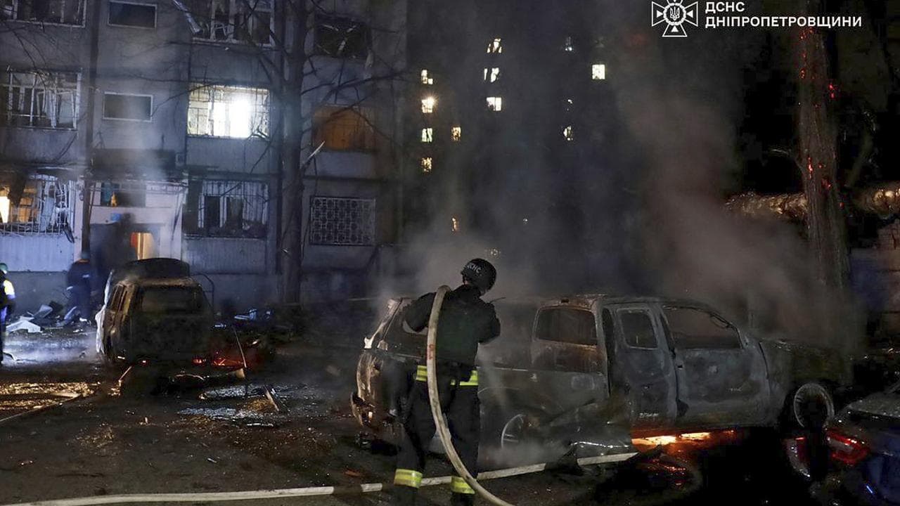 Firefighters extinguish a fire following a Russian attack in Dnipro