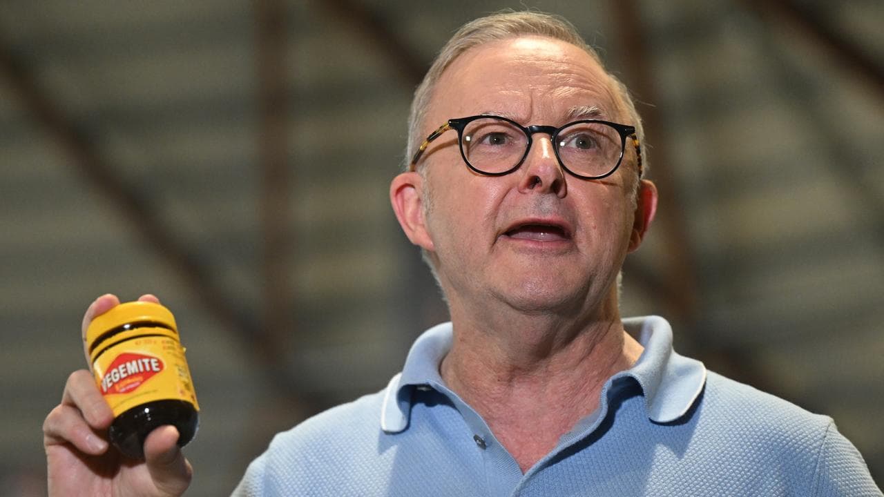 Prime Minister Anthony Albanese holds up a jar of Vegemite