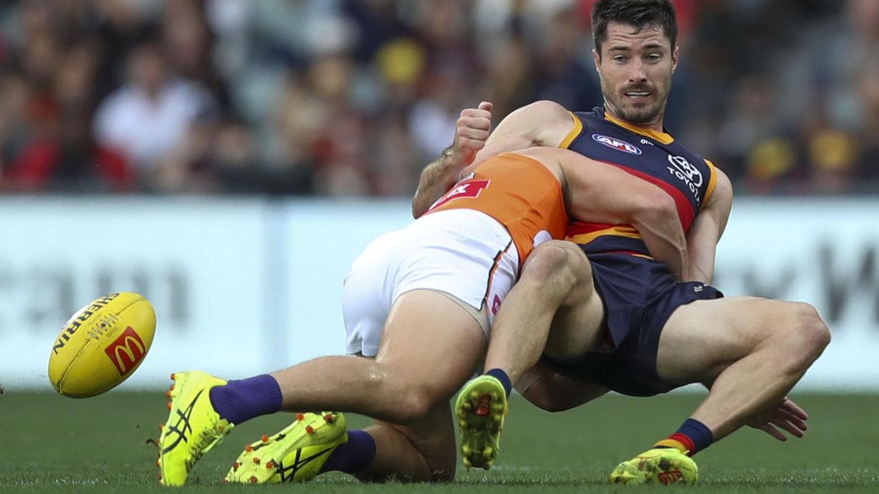 Alex Neal-Bullen is tackled by the Giants' Toby McMullin.