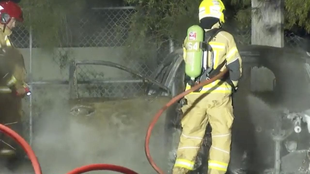 Emergency services at the scene of the burnt-out car (file image)