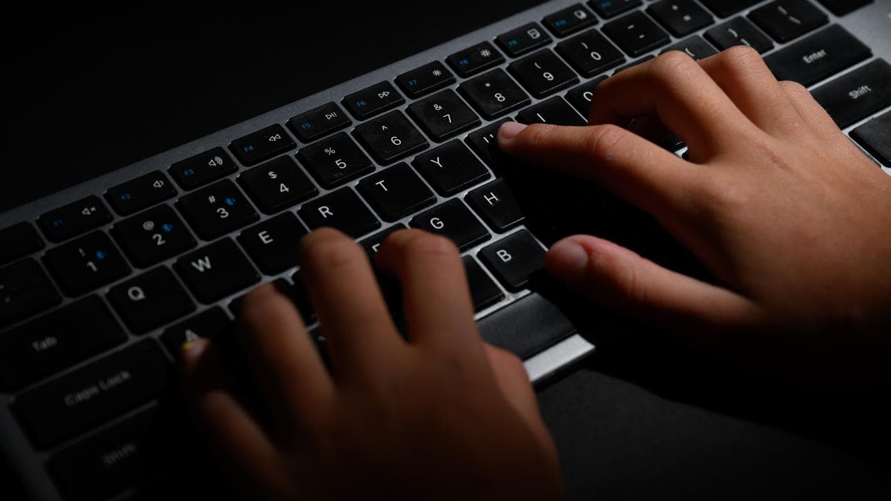 Hands typing on a keyboard