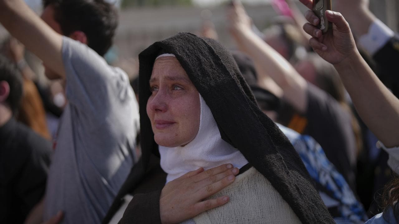 A nun cries as Pope Francis's body is carried into St Peter's Basilica