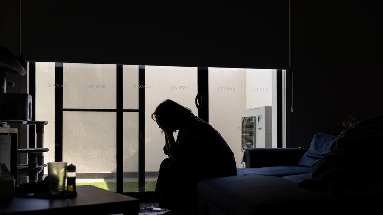 A person poses for a photograph