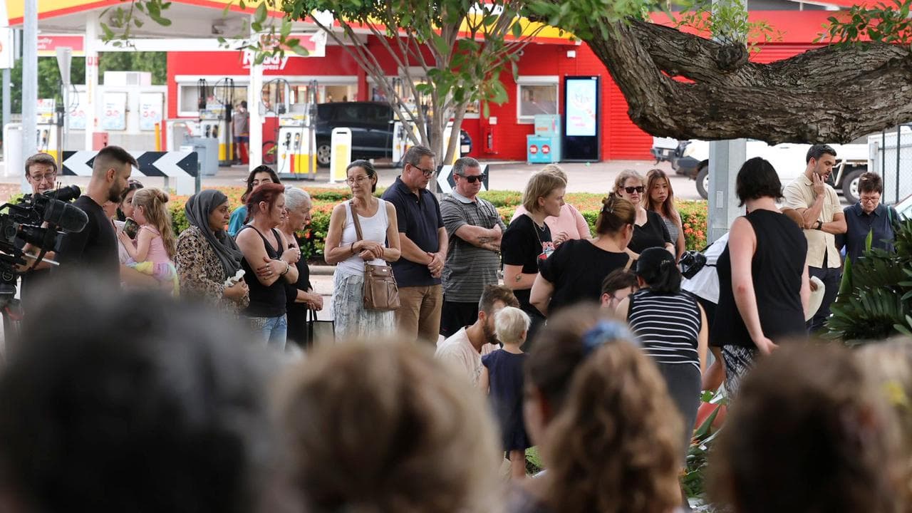 Mourners attend a twilight vigil for Linford Feick
