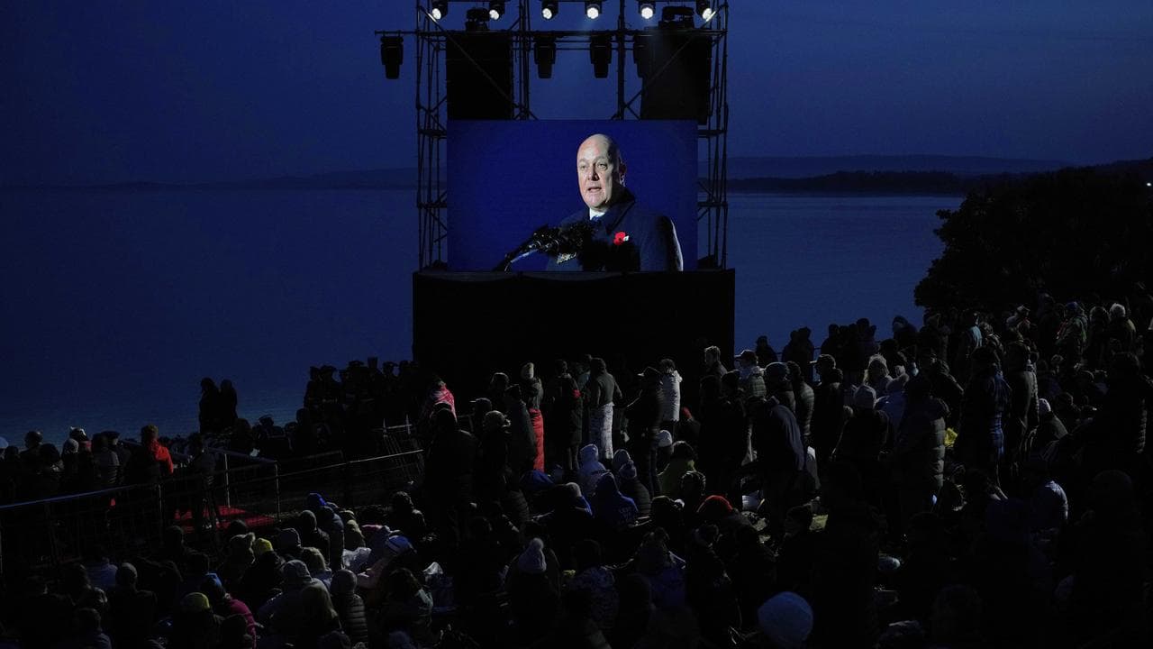 NZ Prime Minster Chris Luxon on a screen at Anzac Cove beach