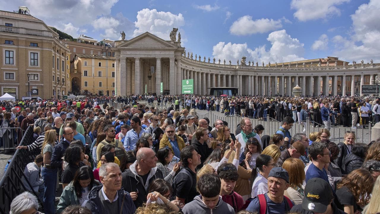 People wait in line to enter St Peter's Basilica