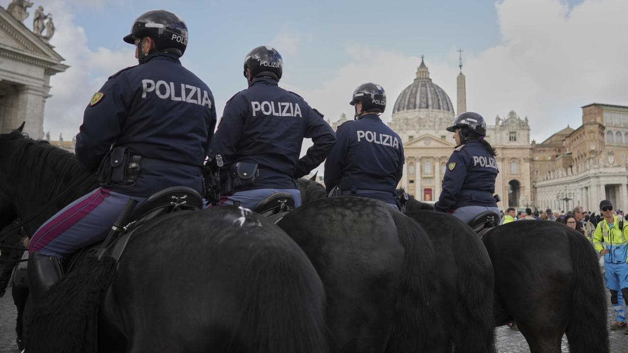 Italian police on horseback patrol in front of St Peter's Basilica