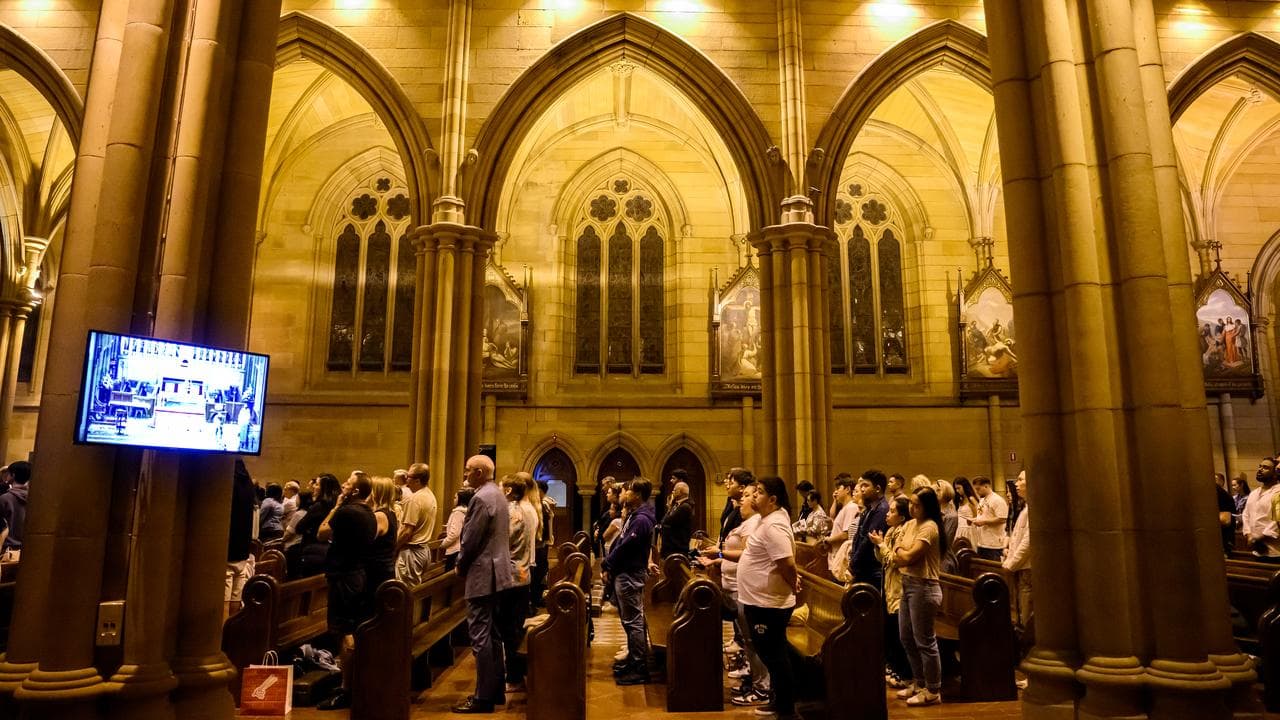 Members of the congregation pray at St Mary’s Cathedral in Sydney