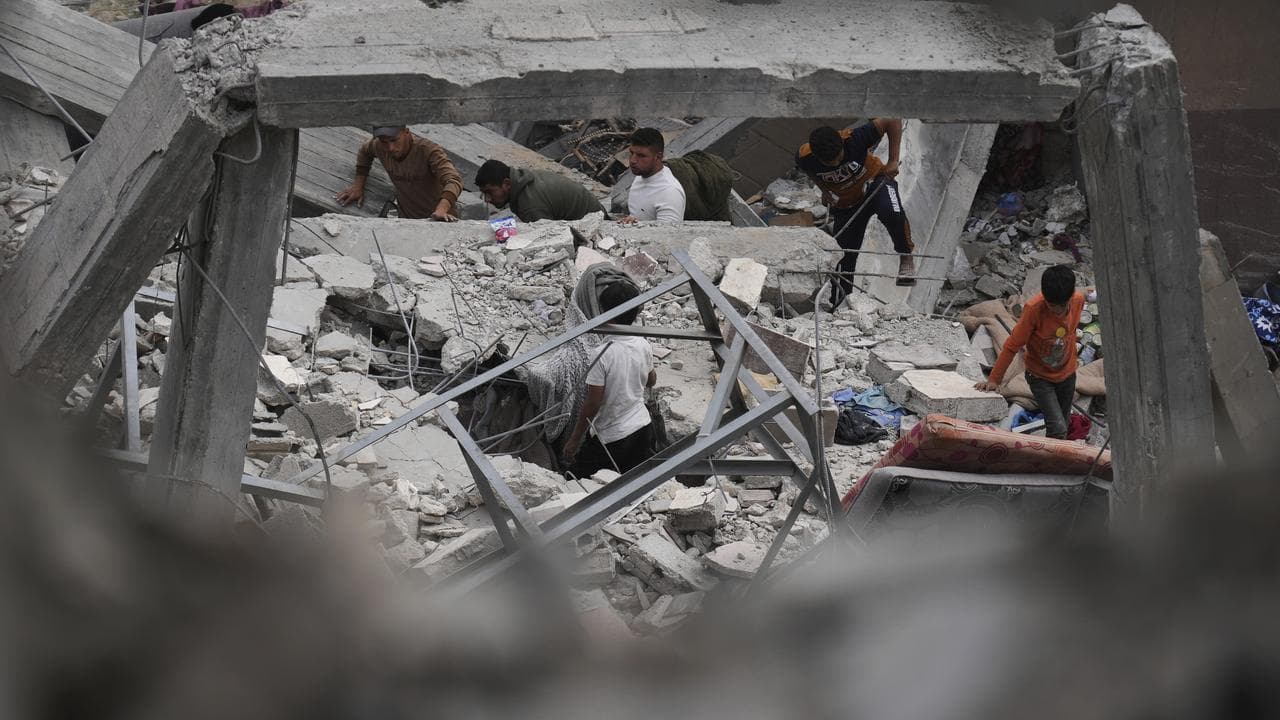 Palestinians inspect the damage caused by an Israeli army strike