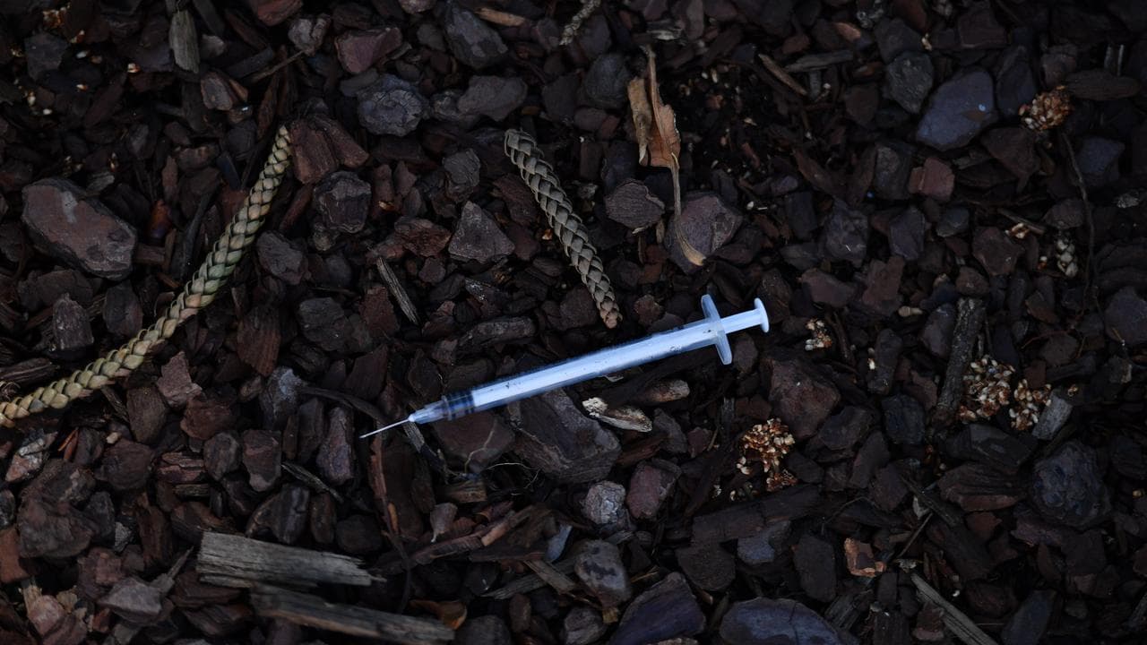 Syringe laying on the ground
