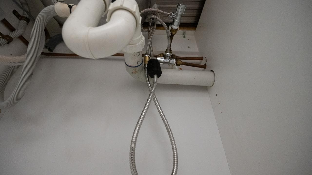 Flexi-hoses under a sink.