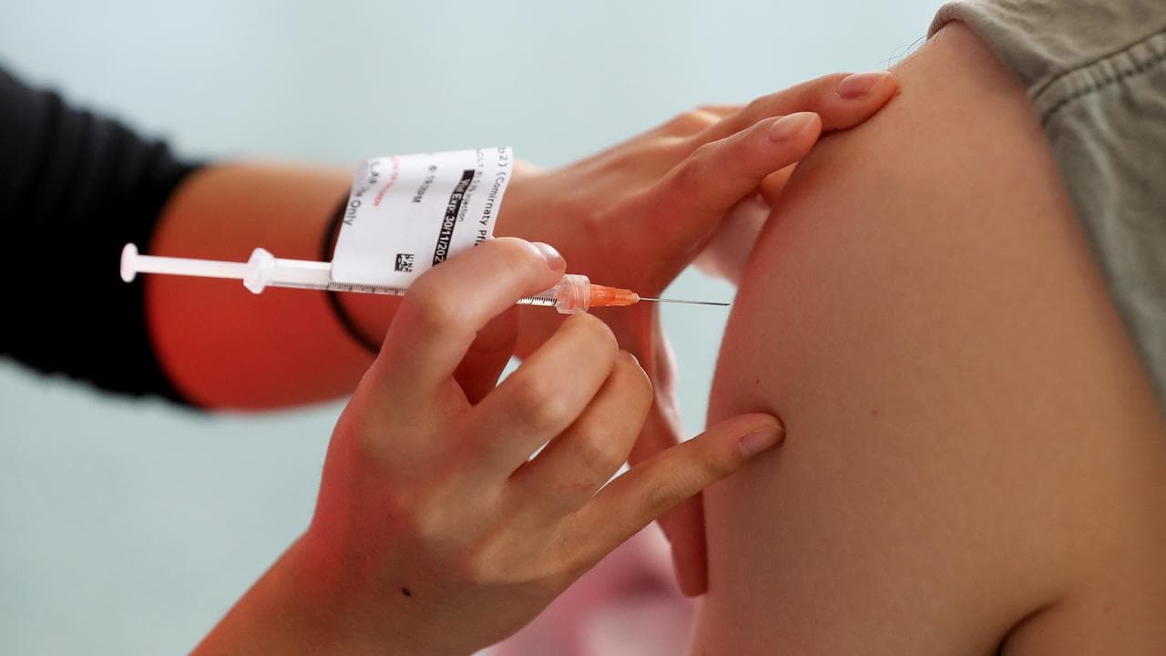 Nurse administers a COVID-19 vaccine into a person's arm