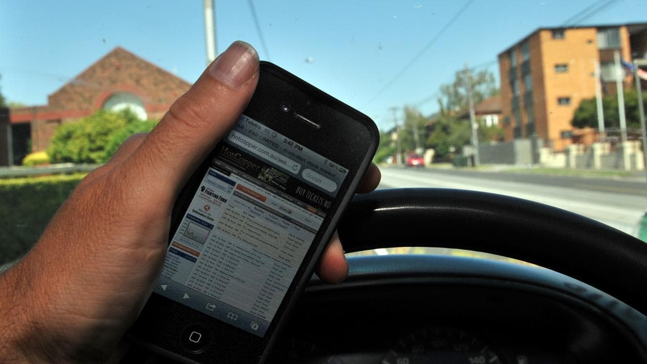 Driver holds mobile phone