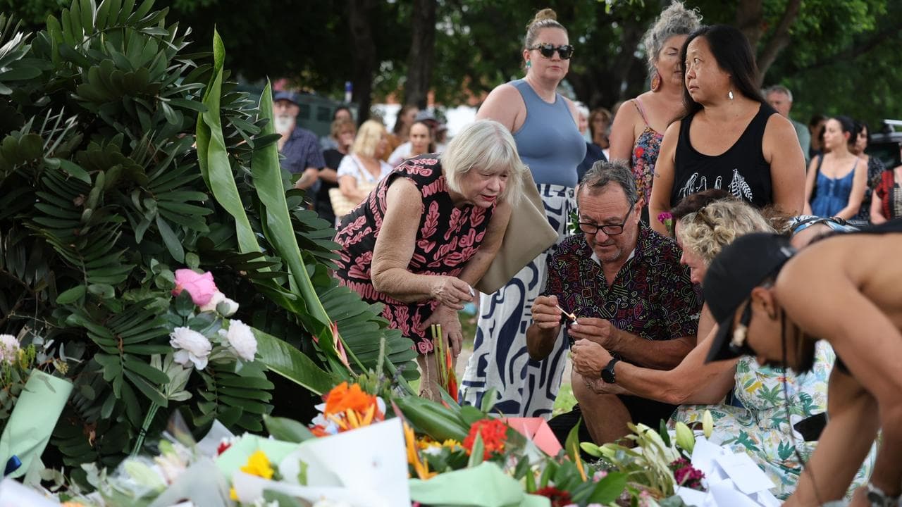 Mourners at a twilight vigil for Linford Feick