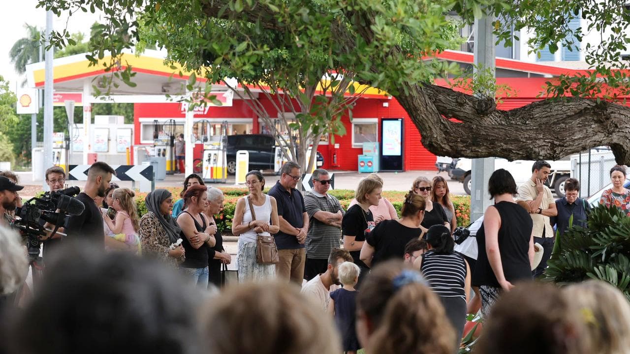 Mourners attend a twilight vigil for Linford Feick.