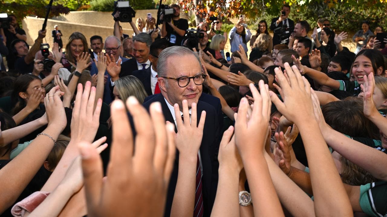 Anthony Albanese is greeted by students