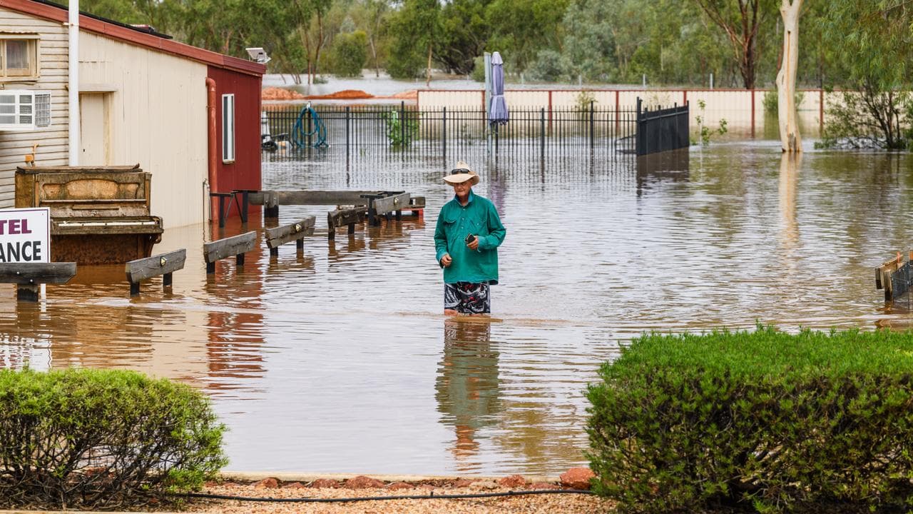 A person walks through flooding in Thargomindah (file image)