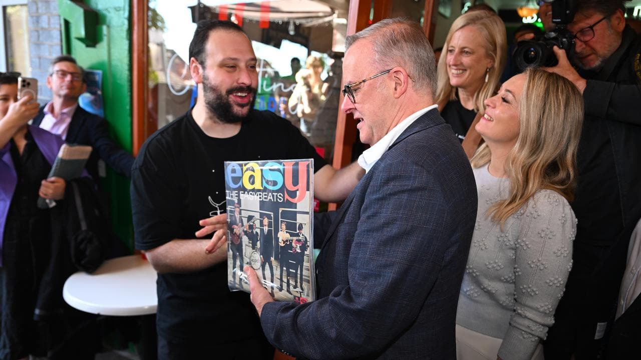 Anthony Albanese receives a record by the Easybeats